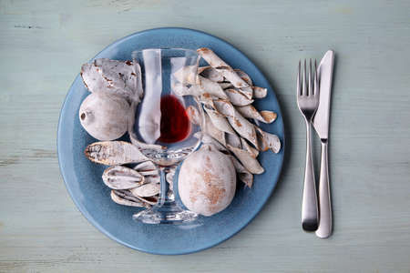 Blue plate with glass of wine and exotic spices and fruits