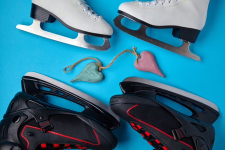Black male and white female ice skates on a blue backgroundの写真素材