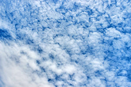 Volumetric blue sky with textured white clouds