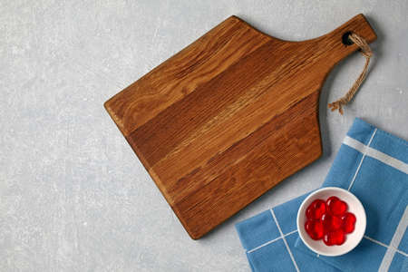 Brown wooden cutting board and bowl with decorative red hearts