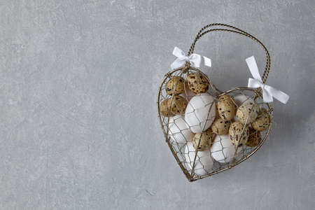 Chicken and quail eggs in a heart shaped box