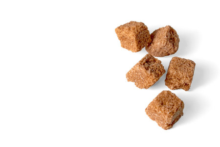 Pieces of brown cane sugar isolated on white background. Fragmenの写真素材