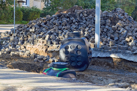 Arrangement of underground communication wells on the repair road site of the city street.