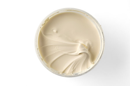 Sour cream full fat yogurt in a transparent bowl isolated on a white background. Top view with copy space.の写真素材