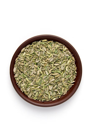 dried fennel seeds in brown clay bowl isolated on white background. top view with copy space.の写真素材