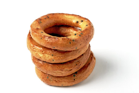 A pyramid of salted pretzels with poppy seeds isolated on a white background.の写真素材