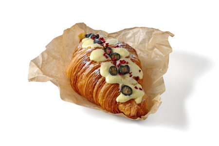 Sweet croissant with berries and cream filling isolated on white background