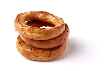 A pyramid of salted pretzels with poppy seeds isolated on a white background