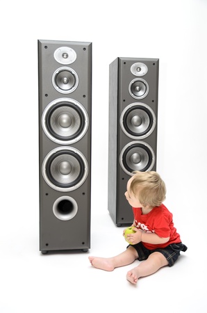 A baby looking curious towards speakersの写真素材