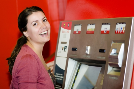 Woman paying at an automatic machineの写真素材
