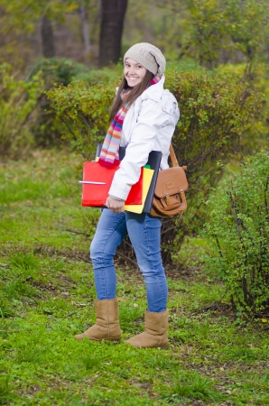 A Young Happy Girl coming from school through forestの写真素材