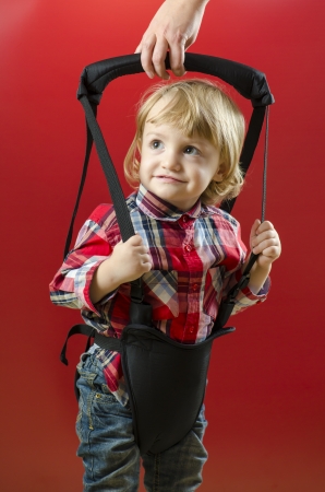A Cute Baby making his First Steps with a harnessの写真素材