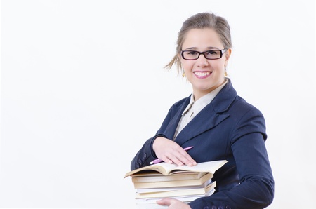 A smiling woman holding a an armful of booksの写真素材