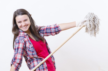 A smiling woman with a washer in her handsの写真素材