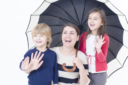 Two children and a woman saying welcomeの写真素材