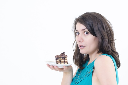 A wishful girl holding a delicious cakeの写真素材