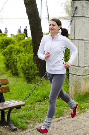 A young woman running in a parkの写真素材