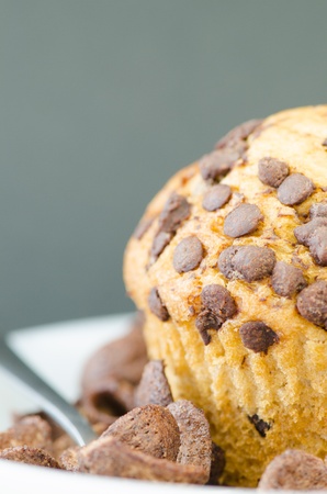 A muffin and chocolate pieces on black backgroundの写真素材