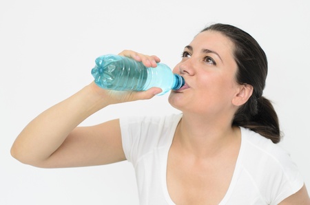 a beautiful thirsty woman drinking water
