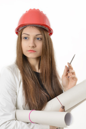 Portrait of female architect holding blueprintsの写真素材