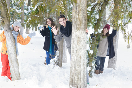 A group of young people playing in the snowの写真素材