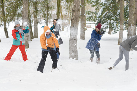 A group of young people playing in the snowの写真素材