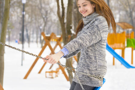 Pretty young girl with long flying hair playing in a parkの写真素材