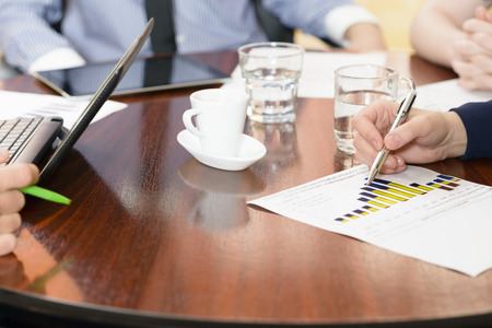 People at office during a meeting working with a financial report