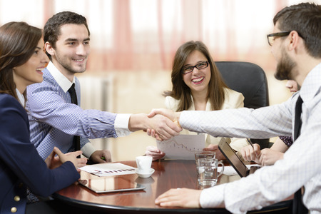 Business group sealing a deal at officeの写真素材