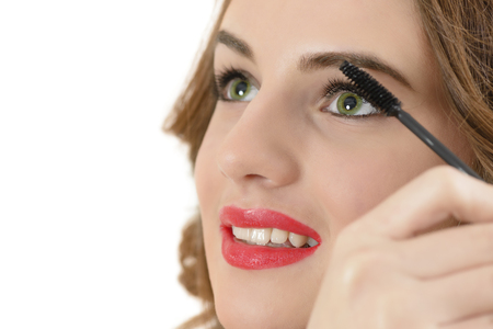 Beautiful sensual woman applying mascara on her eyelashesの写真素材