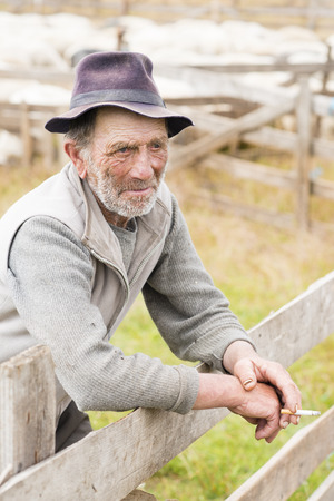 Old shepherd man smoking reflexiveの写真素材