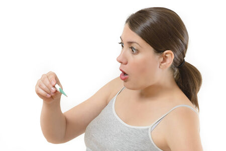 Young woman checking her temperature