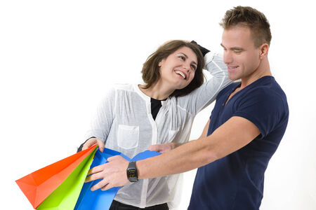 Happy couple coming from shopping isolated on white