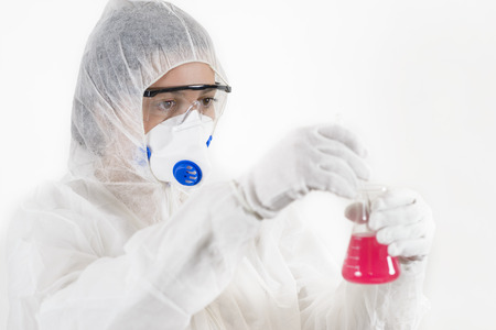 Young Woman wearing protective suit holding some laboratory glassware isolated on white