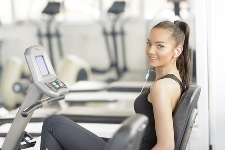 Beautiful woman doing bike exercise at gym