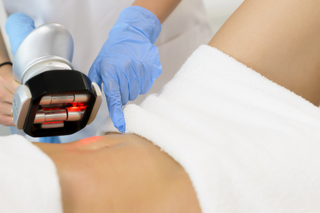 Beautiful woman getting cavitation treatment at beauty salonの写真素材