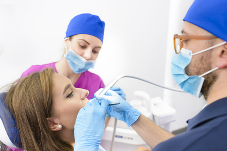 Young beautiful woman getting dental treatmentの写真素材