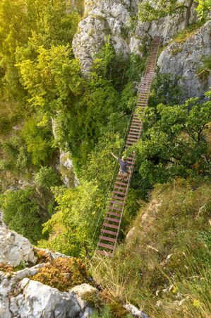 Man walking on via ferrata trail, Casa Zmeului, Romaniaの写真素材
