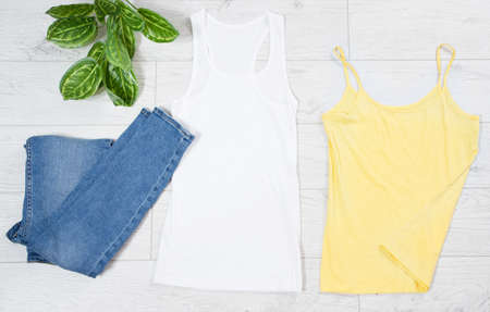White and yellow T-shirt and jeans denim top view - casual clothes backgroundの写真素材
