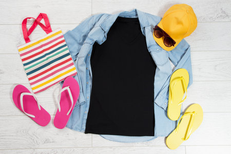 T shirt top view, empty blank t-shirt copy space, tshirt mock up, summer concept. Summer clothes background. Empty flatlay shirt on wooden floorの写真素材