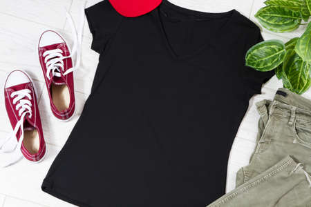 Black casual t-shirt mock up top view - casual clothes background.