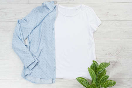 tshirt t-shirt t shirt mock up top view on wooden floor, clothes background copy space shirt flatlay