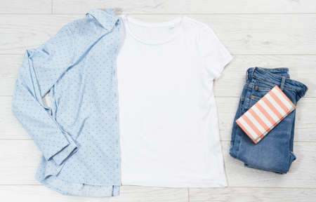 T-shirt mock up, tshirt top view, White closeup t shirt mock up flat lay on white wooden background. Top view and copyspace. Mockup t-shirt and summertime. Template blank shirt.の写真素材
