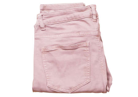 Female pants, light pink denim pants top view isolated on white background, folded slim pantsの写真素材