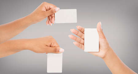 set several variants black hands hold business card isolated on grey background, blank,mockupの写真素材