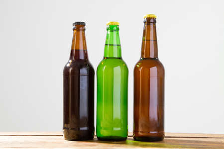 Beer bottles on a wooden table . Top view. Selective focus. Mock up. Copy space.Template. Blank.の写真素材