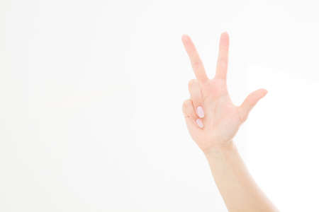 hand showing the sign of victory or peace closeup isolated on white background.Front view. Mock up. Copy space. Template. Blank.の写真素材