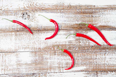 Decoration of red hot chili pepper on wodden board. Set, copy space, mock upの写真素材