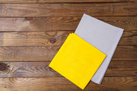 yellow and grow napkins on old wooden table, food drink concept, mock upの写真素材