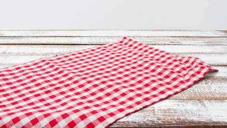checkered tablecloth on wooden table on gray backgroundの写真素材